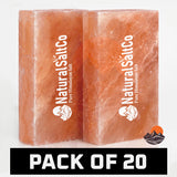 Two rectangular blocks of Natural Salt Co. Himalayan salt in a warm orange-pink hue, shown side by side on a white background with a black banner at the bottom reading 'PACK OF 20'.
