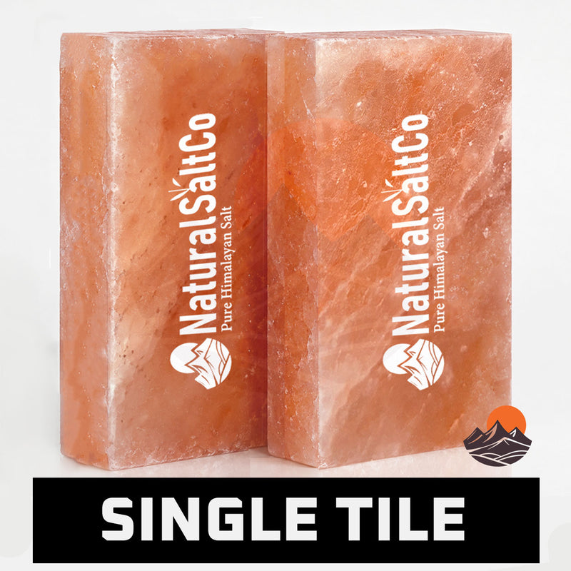 Two rectangular pinkish-orange salt blocks with white 'NaturalSaltCo' branding, shown on a white background with a black banner at the bottom reading 'SINGLE TILE'.