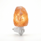 Himalayan salt lamp with a white base on a white background