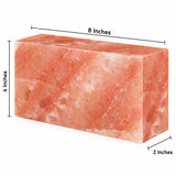 A rectangular pink stone block with dimension labels showing 8 inches across the top, 4 inches on the left side, and 2 inches on the front face, on a white background.