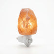 Himalayan salt lamp with a plug on a white background
